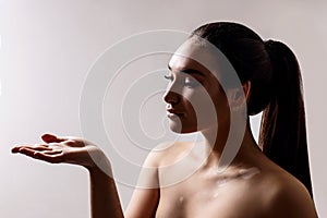 Beautiful woman with vitiligo showing empty hand.