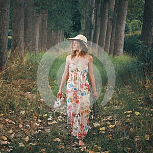 Beautiful woman walking barefooted in nature