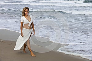 Beautiful woman walking on beach