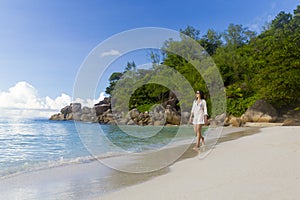 A beautiful woman walking on the beach