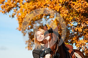 Beautiful woman walking with horse