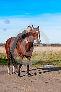 Beautiful woman walking with horse