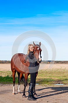 Beautiful woman walking with horse