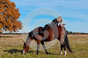 Beautiful woman walking with horse