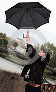 Beautiful woman walking on street with umbrella photo