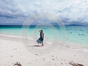 Beautiful woman walking by the white sand beach in Thailand, Phi Phi islands