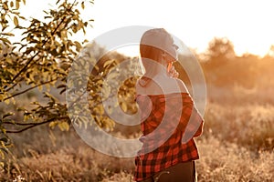 Beautiful woman in the warm rays of the setting sun