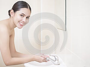 A beautiful woman is washing her face