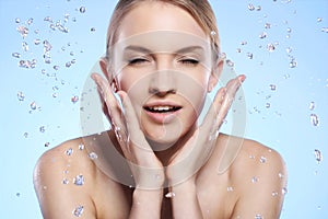 Beautiful woman washing her face