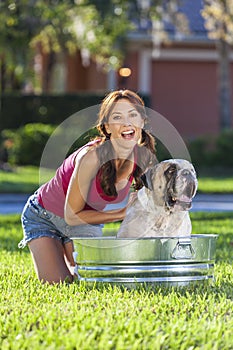 Beautiful Woman Washing Her Pet Dog In A Tub