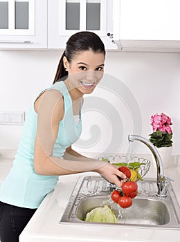Beautiful woman Washing vegetables