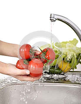 Beautiful woman Washing vegetables