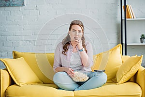 beautiful woman watching movie and eating popcorn