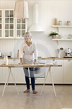 Beautiful woman wear apron flattening dough smile posing for camera