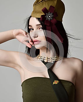 Beautiful woman wear fashion military cloth dark green hat uniform on holiday day of victory May 9 Russia