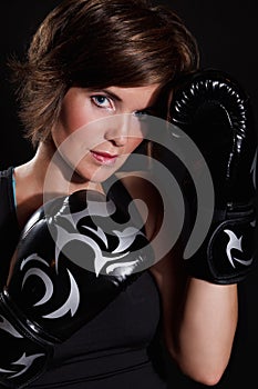 Beautiful woman wearing boxing gloves