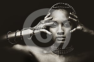 Beautiful woman wearing chain jewellery in black and white photo