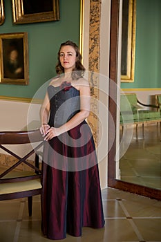 Beautiful woman wearing corset posing in palace