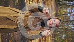 Beautiful woman wearing elegant clothes, walking in park in autumn.