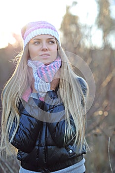 Beautiful woman wearing hat, scarf and down jacket in cold weather