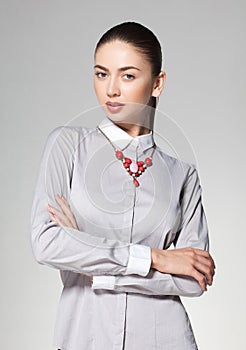 Beautiful woman wearing necklace on grey background