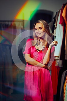 Beautiful Woman Wearing a Pink Cocktail Dress in a Fashion Store