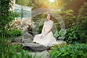 Beautiful woman wearing prom dress in japanese garden outdoors