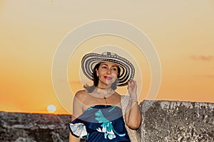 Beautiful woman wearing the traditional Colombian hat called Sombrero Vueltiao at the historical streets of the Cartagena de