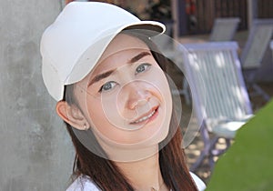 Beautiful woman wearing white hat bitting her sexy lip.