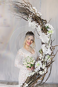 Beautiful woman in wedding dress in photo studio.