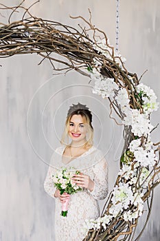 Beautiful woman in wedding dress in photo studio.