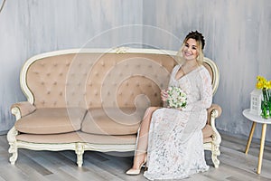 Beautiful woman in wedding dress in photo studio.