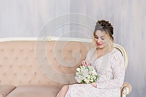 Beautiful woman in wedding dress in photo studio.