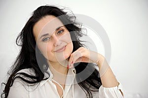 beautiful woman on a white background black hair gently smiling space for text advertising Beauty company worker