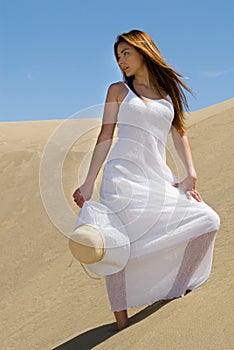 Beautiful woman in white in the desert