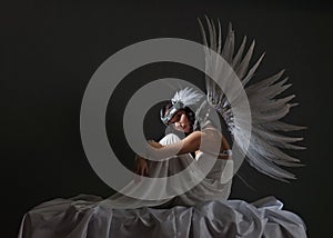 Beautiful woman in white dress with angel wings