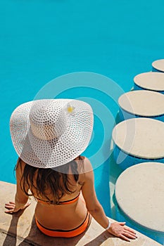 Beautiful woman in a white hat sitting