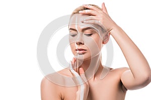 beautiful woman with white lines on face touching head with hands