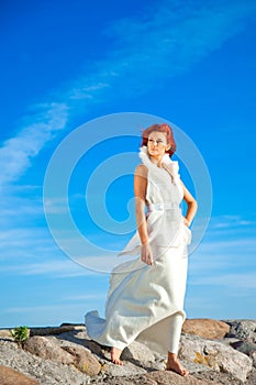 Beautiful woman in white on seacoast
