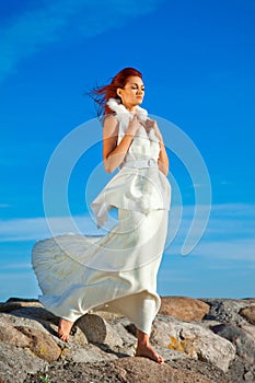 Beautiful woman in white on seacoast