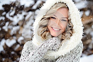 A beautiful woman with white teeth and a perfect smile. Happy sincere winter outdoor portrait of a attractive model