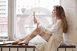 Beautiful woman in white underwear and negligee at home in the bathroom. A woman in love is resting