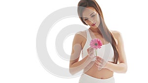 Beautiful woman in white underwear over isolated white background. Close-up studio video of healthy young girl in