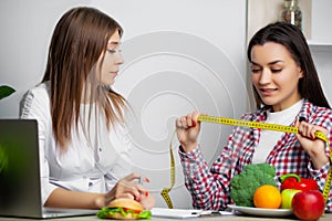 Beautiful woman who makes a choice between useful and harmful food