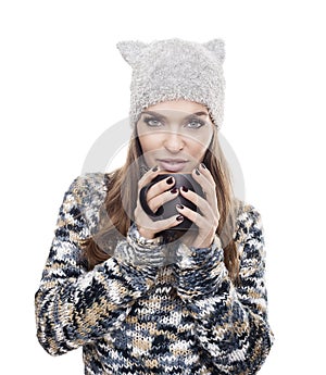 Beautiful woman with winter clothes and mug of coffee
