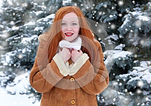 Beautiful woman on winter outdoor, snowy fir trees in forest, long red hair, wearing a sheepskin coat