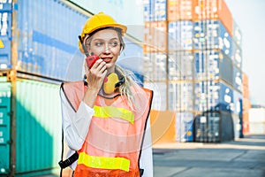 Beautiful woman worker working at Container cargo harbor. Dock female staff business Logistics import export shipping concept