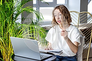 Beautiful woman working on laptop at home. Business meeting online