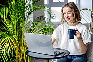 Beautiful woman working on laptop at home. Business meeting online