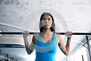 Beautiful woman working out with barbell